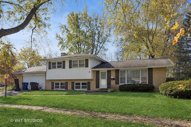 split level home featuring a garage and a front lawn