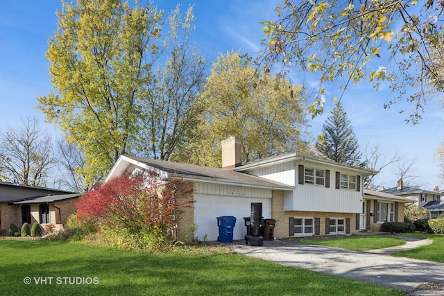 back of property with a garage and a yard