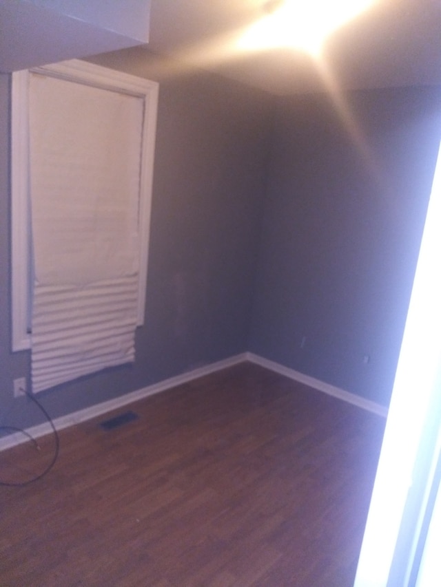 unfurnished room with dark hardwood / wood-style floors