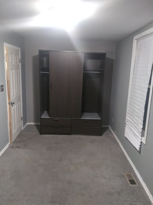 unfurnished bedroom featuring carpet floors and a closet