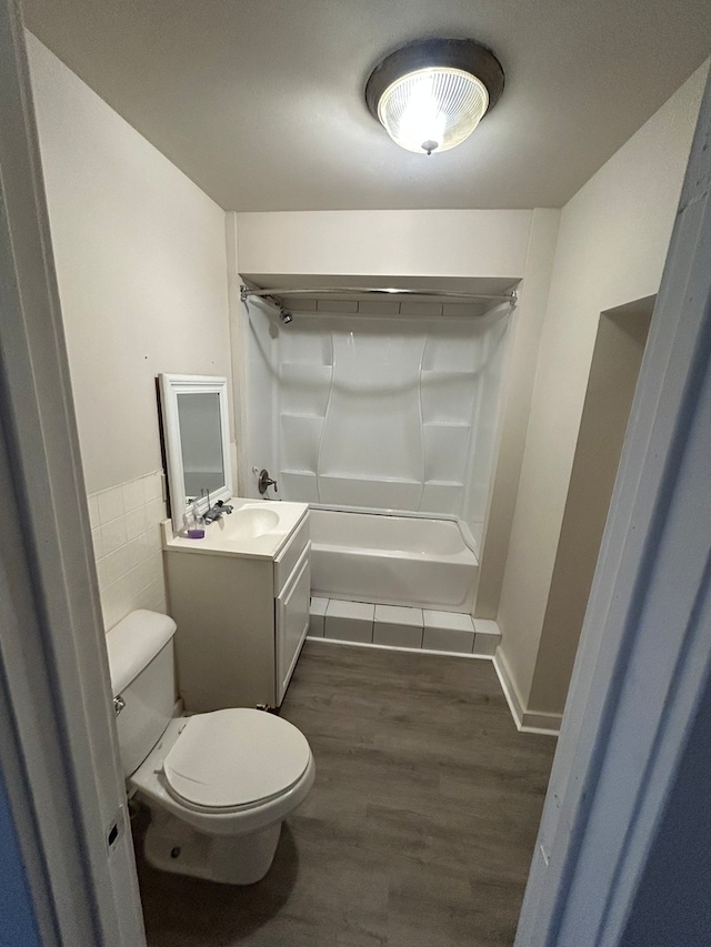 full bathroom with vanity, wood-type flooring, toilet, and bathing tub / shower combination