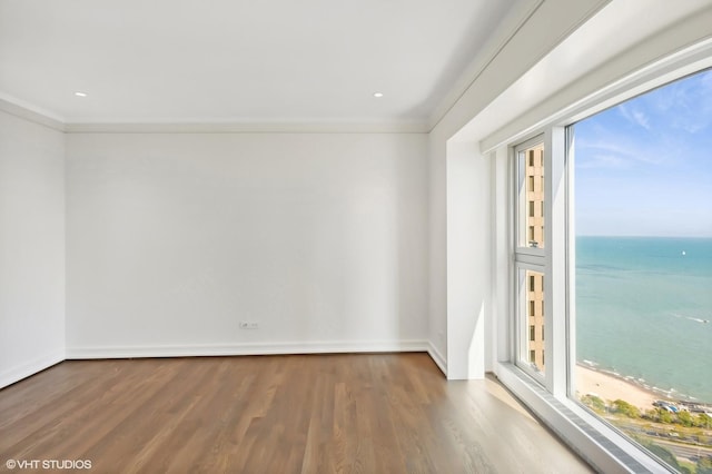 77 E Walton St Unit 28B, Chicago, IL 60611 - unfurnished room with healthy amount of natural light, wood finished floors, ornamental molding, a water view, and baseboards
