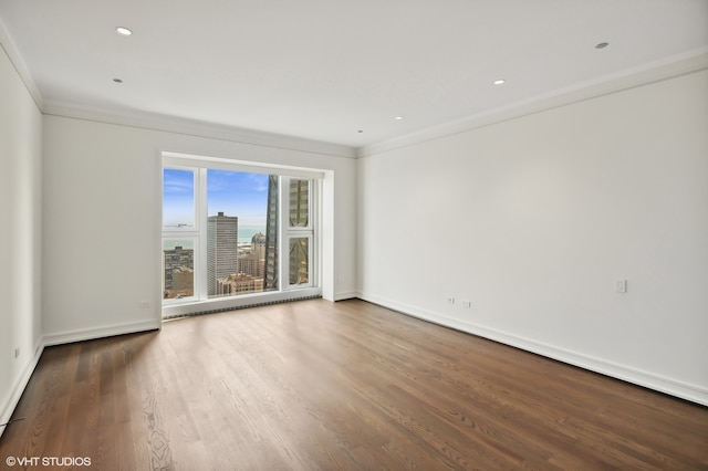 unfurnished room with hardwood / wood-style floors and crown molding