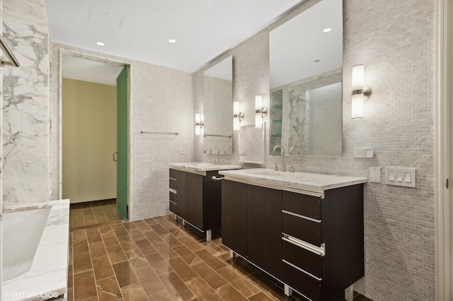 bathroom featuring vanity and tile walls