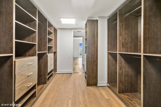 walk in closet featuring light hardwood / wood-style flooring