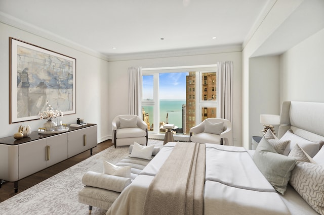 bedroom with dark hardwood / wood-style floors, a water view, and ornamental molding