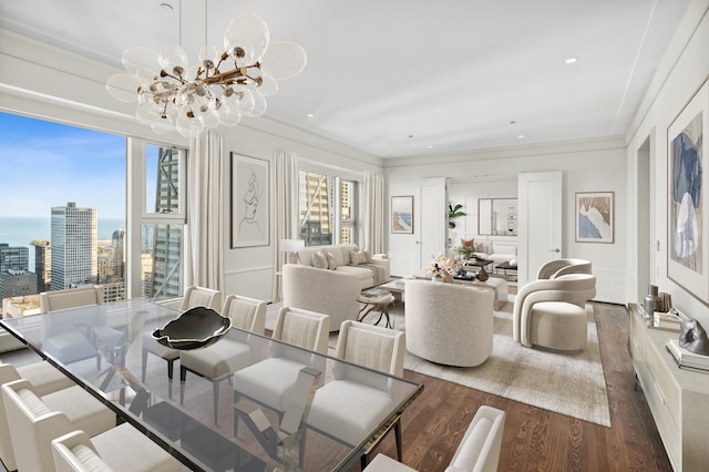 dining room with dark hardwood / wood-style floors, crown molding, and an inviting chandelier