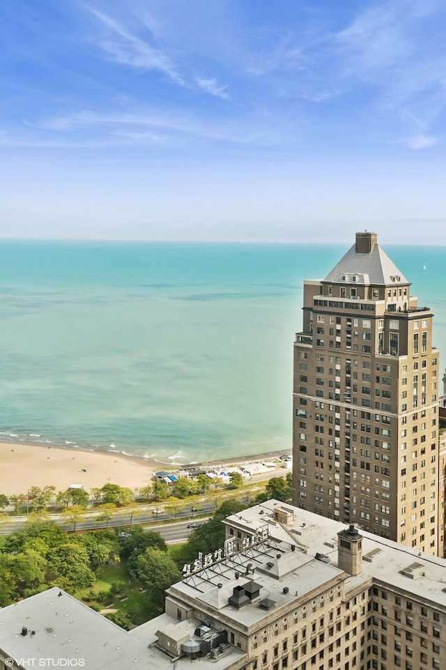 birds eye view of property with a beach view and a water view