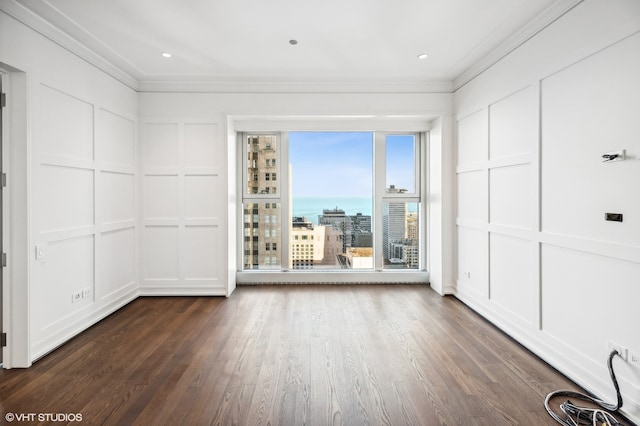 empty room featuring dark hardwood / wood-style floors and crown molding