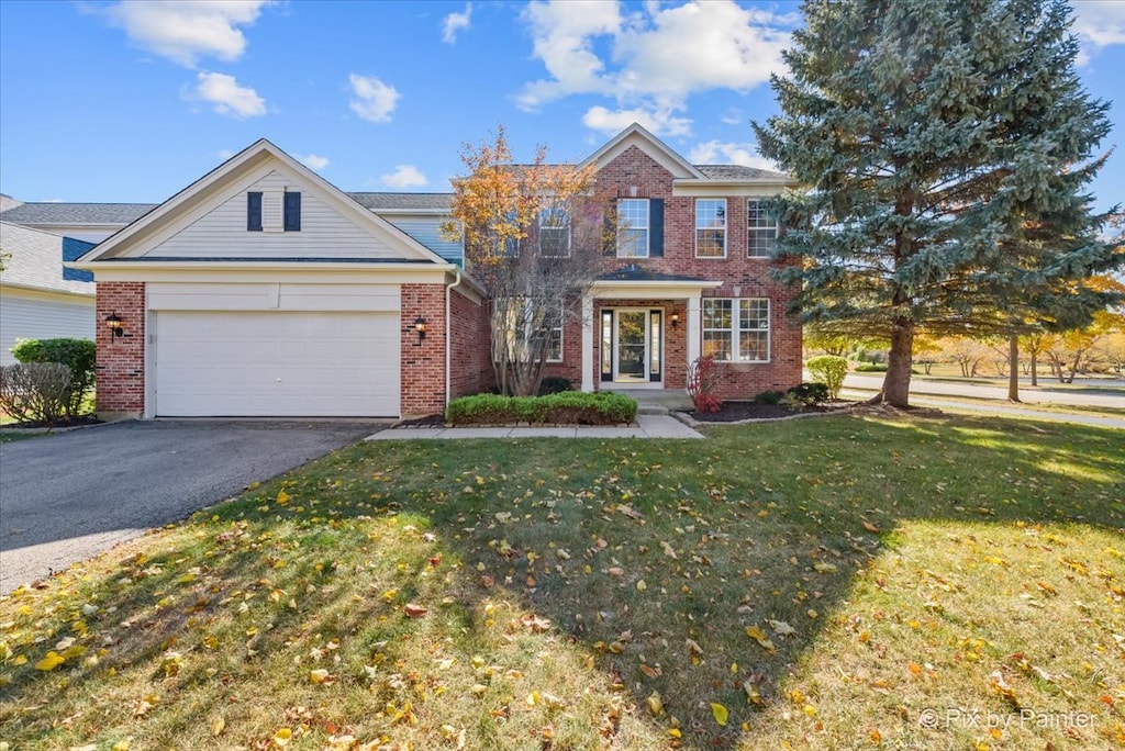 view of front of house with a front lawn and a garage