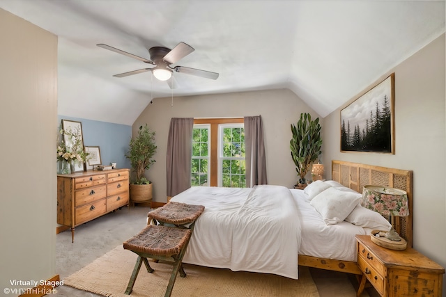 bedroom featuring ceiling fan, light colored carpet, and vaulted ceiling