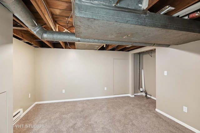 basement with carpet and a baseboard radiator