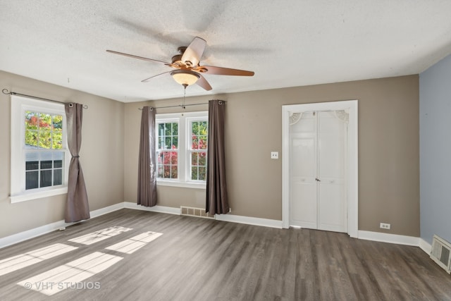 spare room featuring hardwood / wood-style floors, a textured ceiling, and ceiling fan