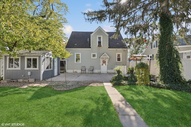 rear view of property with a lawn and a patio