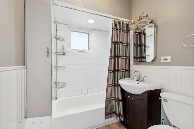 full bathroom with vanity, shower / tub combo, and toilet