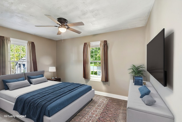 bedroom with multiple windows and ceiling fan