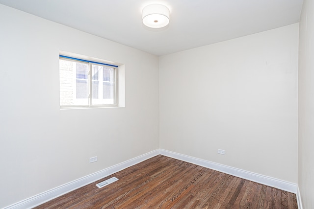 empty room featuring dark hardwood / wood-style flooring