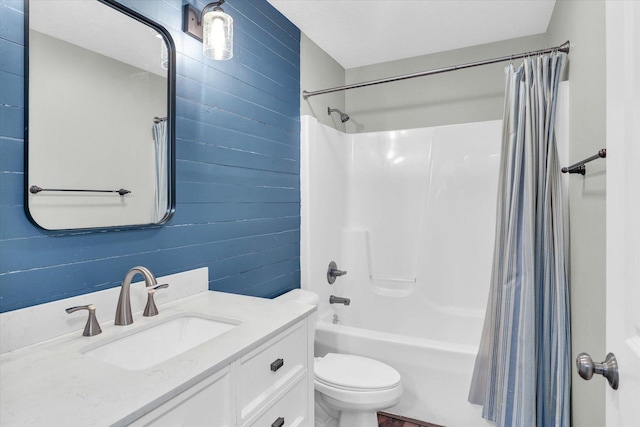 full bathroom with vanity, shower / bath combo with shower curtain, and toilet