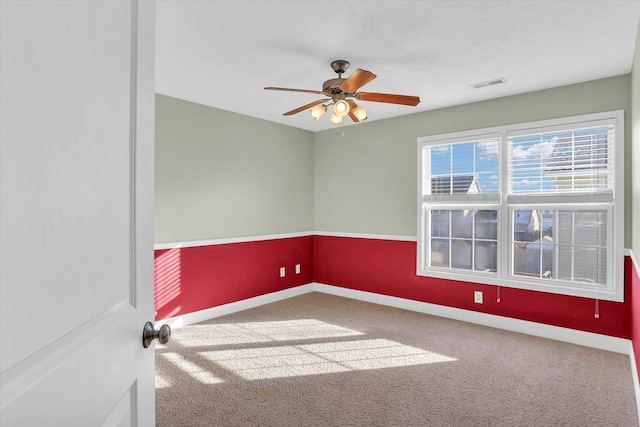 empty room featuring ceiling fan and carpet flooring