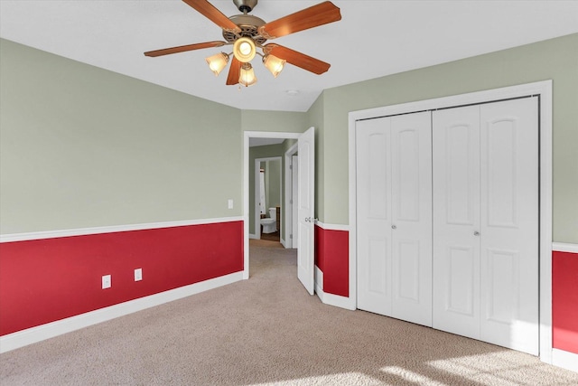 unfurnished bedroom featuring ceiling fan, carpet flooring, and a closet