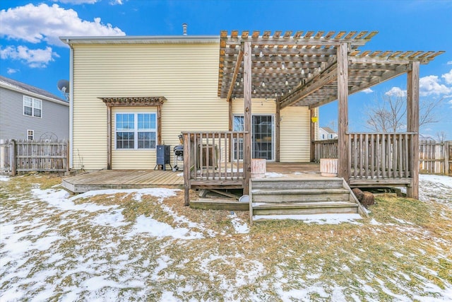 snow covered property with a wooden deck and a pergola