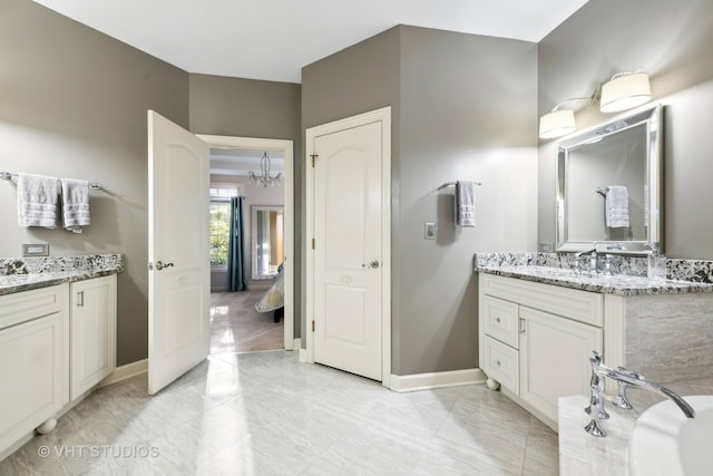 bathroom with vanity and an inviting chandelier