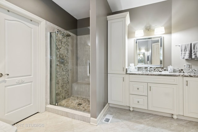 bathroom featuring vanity and a shower with shower door