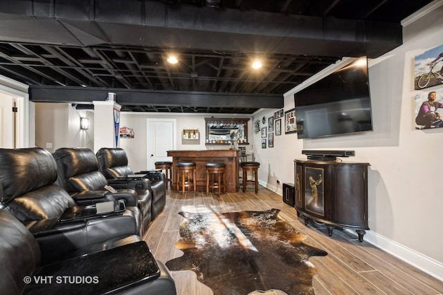 living room featuring bar area and hardwood / wood-style flooring