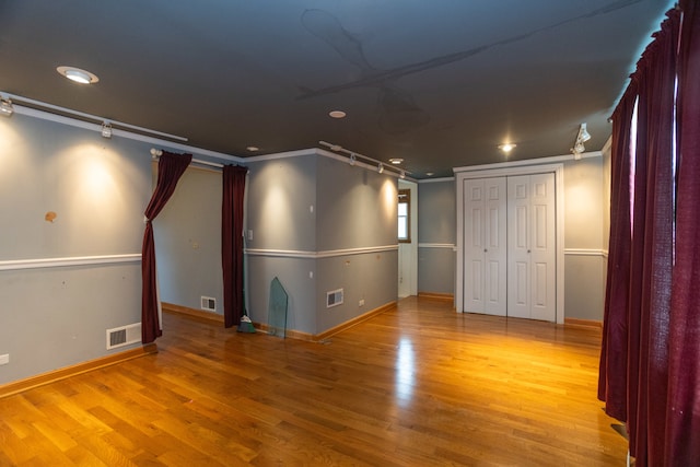 interior space with hardwood / wood-style flooring and ornamental molding