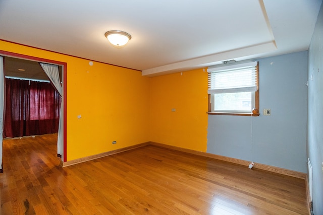 spare room featuring wood-type flooring