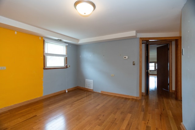 spare room with wood-type flooring