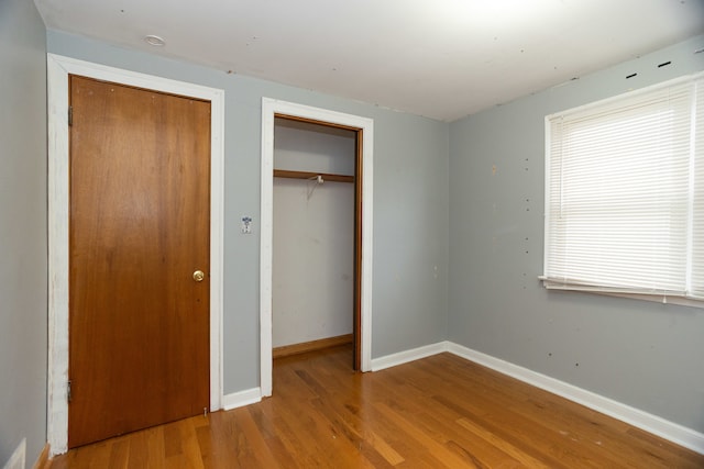 unfurnished bedroom with hardwood / wood-style floors