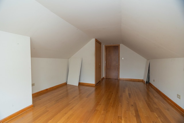 bonus room with wood-type flooring and lofted ceiling