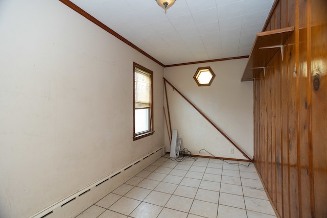 unfurnished room featuring ornamental molding and a baseboard heating unit