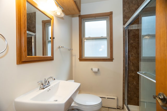 bathroom with a baseboard radiator, toilet, walk in shower, and sink