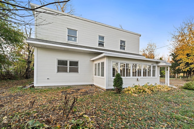 rear view of property with a sunroom