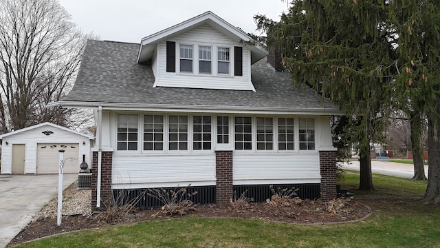 view of front facade featuring an outbuilding and a garage