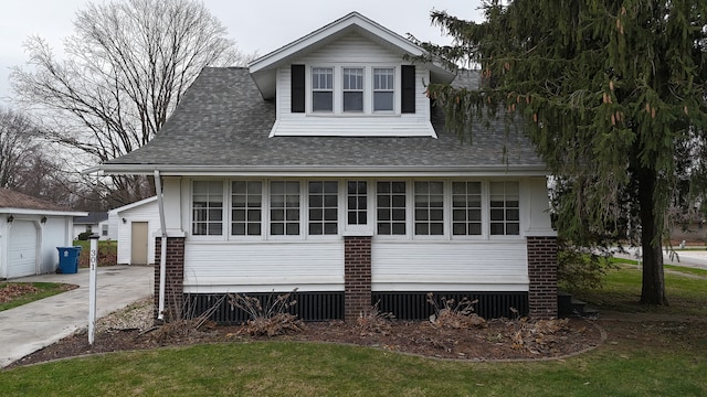 exterior space featuring a garage and an outbuilding