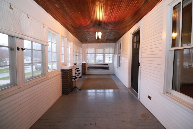 unfurnished sunroom featuring wood ceiling