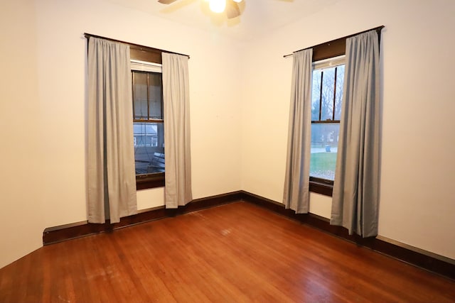 spare room with ceiling fan and dark hardwood / wood-style floors