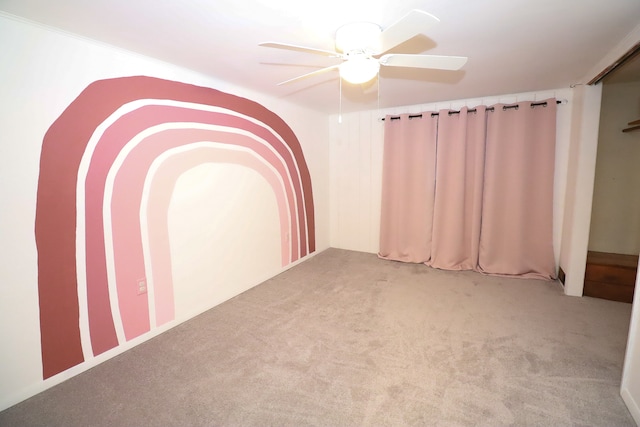 spare room featuring ceiling fan and light colored carpet