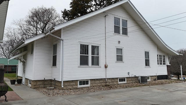 view of side of home featuring central AC