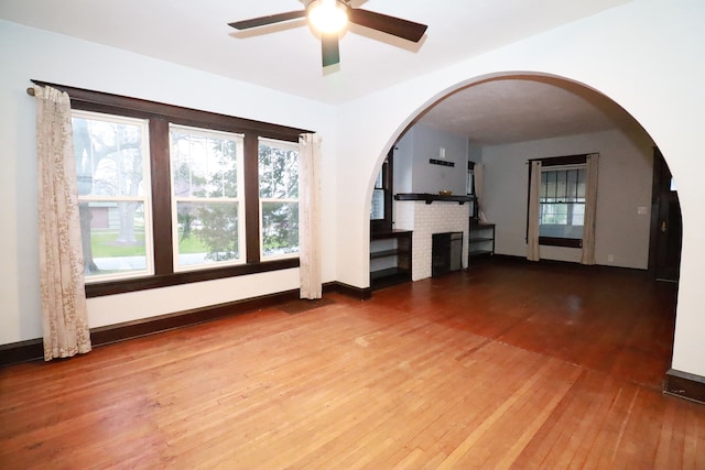 unfurnished living room with hardwood / wood-style flooring and ceiling fan