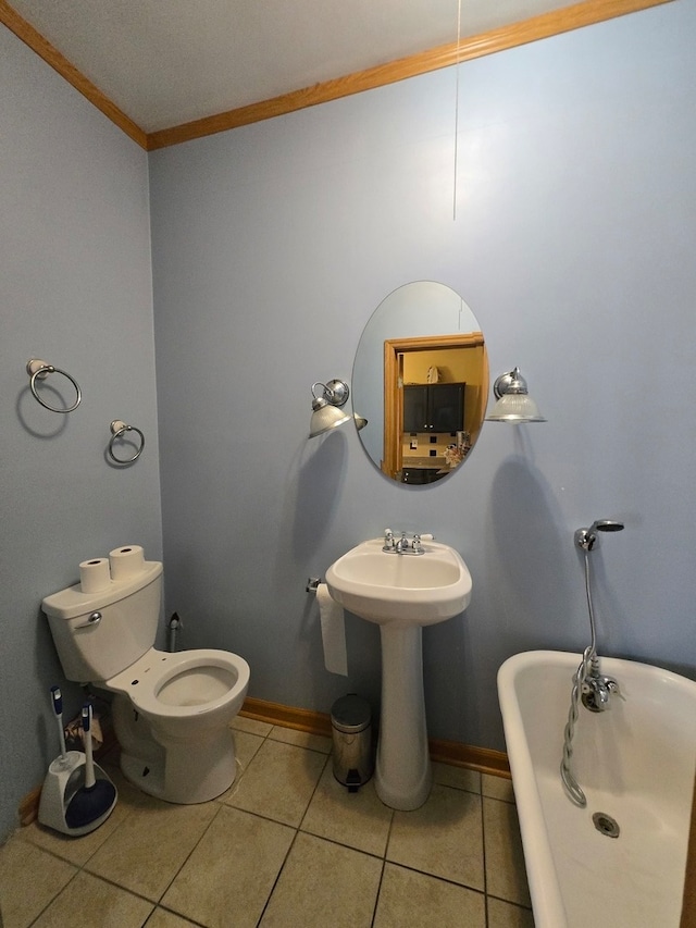 bathroom featuring a bathtub, toilet, crown molding, sink, and tile patterned flooring