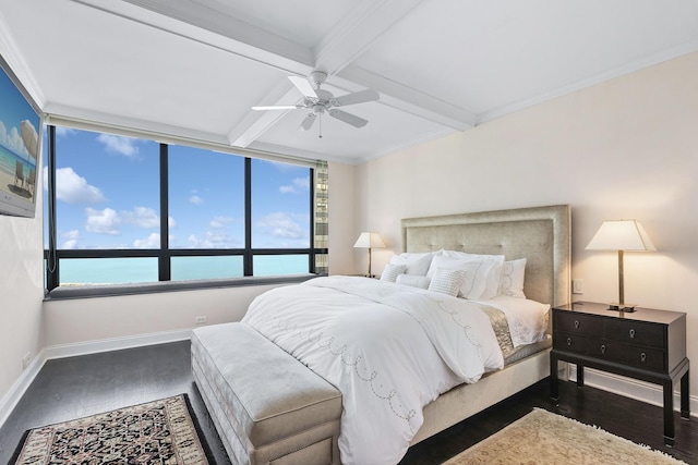 bedroom featuring dark wood-type flooring, beamed ceiling, ceiling fan, and a water view