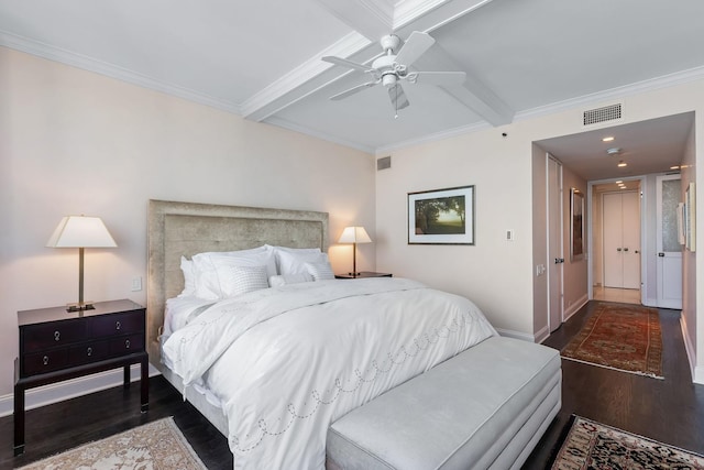 bedroom with dark wood-type flooring, coffered ceiling, crown molding, ceiling fan, and beam ceiling