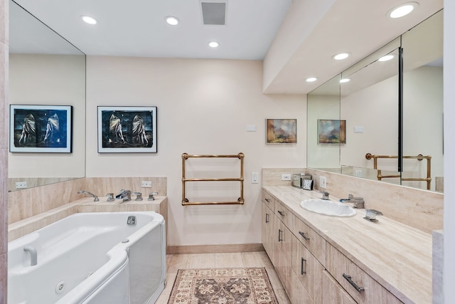 bathroom featuring tile patterned flooring, vanity, and a bath