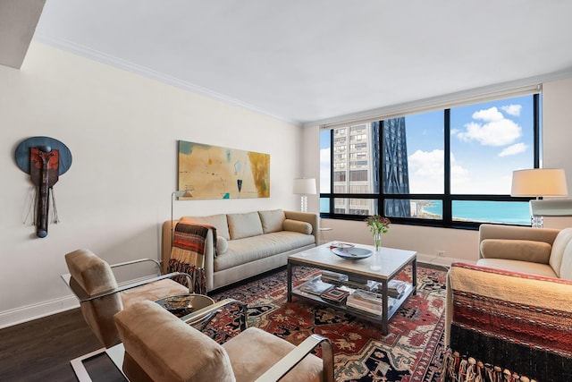 living room with crown molding, a water view, plenty of natural light, and hardwood / wood-style floors