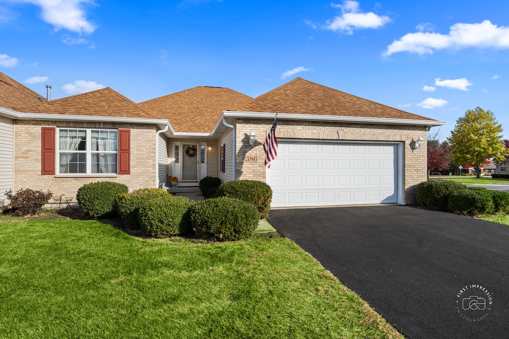 ranch-style house with a front yard and a garage