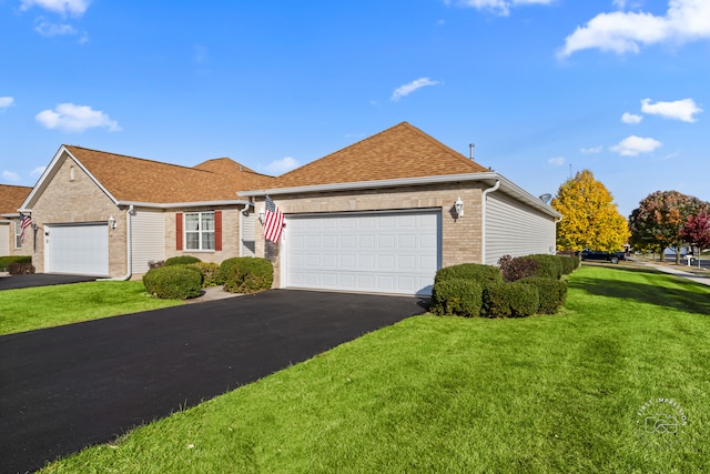 view of front of house featuring a front yard and a garage